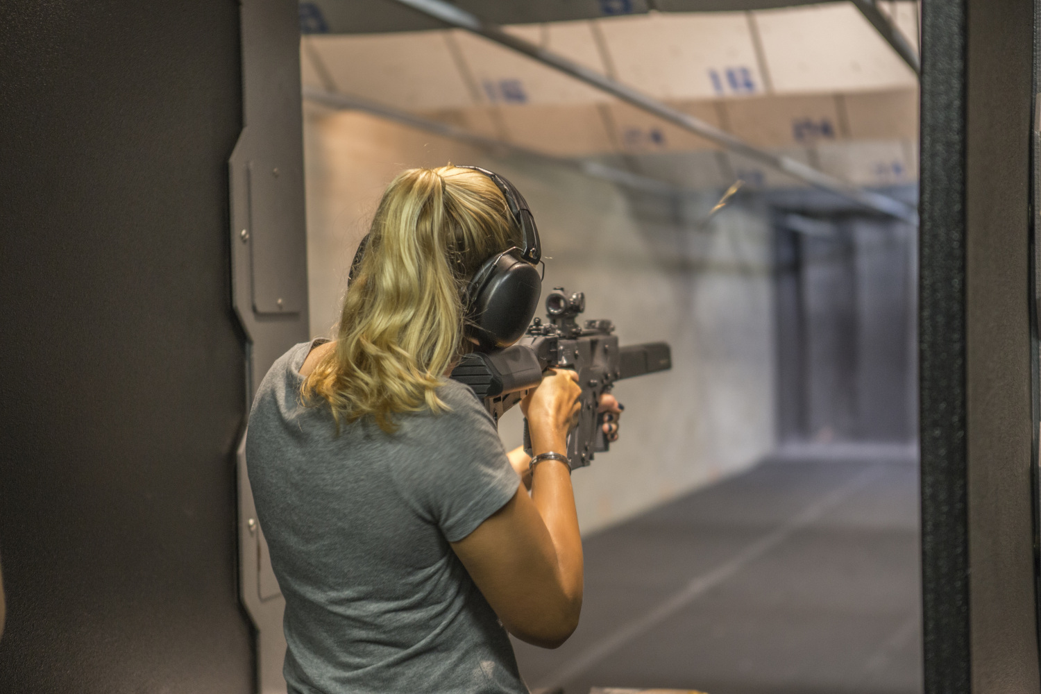 Woman,Shooting,At,Firing,Range.